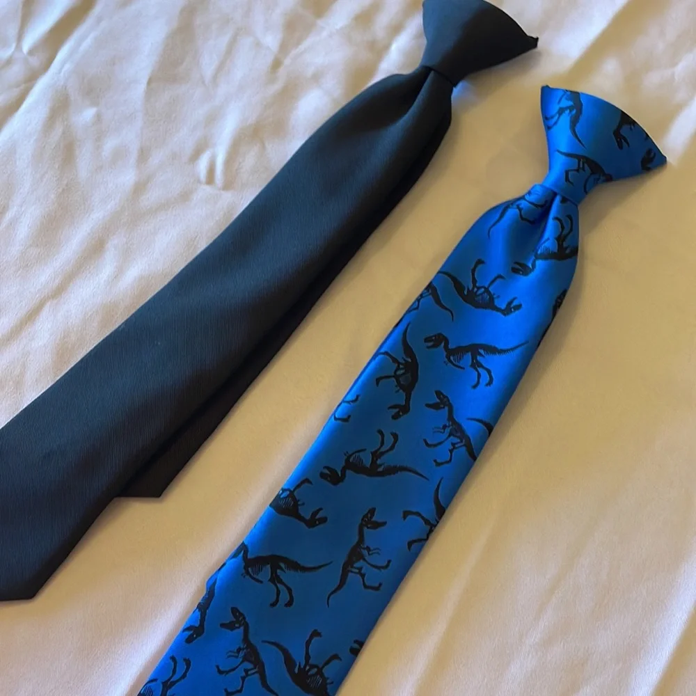 2 clip on ties. One black, one blue with dinosaurs. Very cute. Boys size 6-8
